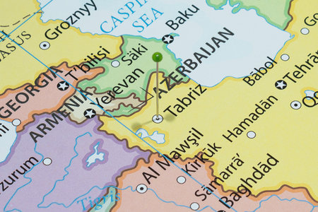 Close up to a Tabriz city with a green pin needle into Iran political country mapの写真素材