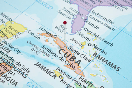Close up to a Santa Clara city with a red pin needle into Cuba country political mapの写真素材