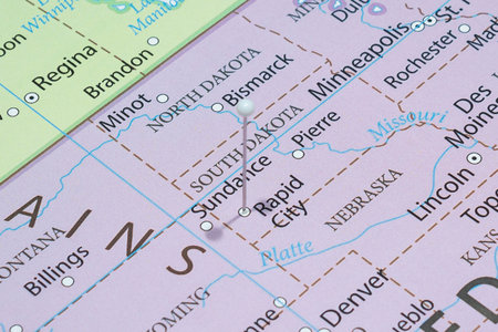 Close up to a Rapid City with a white pin needle into United States of America country political mapの写真素材