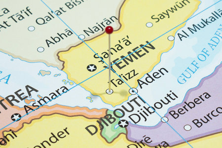 Close up to a Taizz city with a red pin needle into Yemen country political mapの写真素材