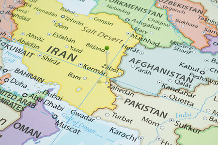 Close up to a Zahedan city with a green pin needle into Iran country political mapの写真素材