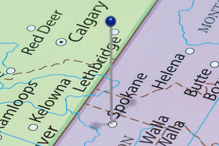Close up to a Spokane city with a blue pin needle into United States of America country political...