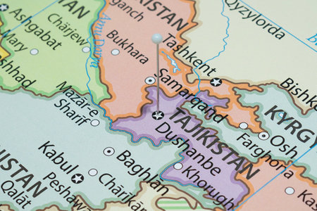 Close up to a Dushanbe city with a white pin needle into Tajikistan country political mapの写真素材