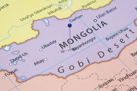 Close up to a Bayankhongor city with a blue pin needle into Mongolia country political mapの写真素材