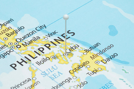 Close up to a Cebu city with a white pin needle into Philippines country political mapの写真素材