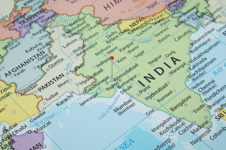 Close up to an Ahmadabad city with an orange pin needle into India country political mapの写真素材