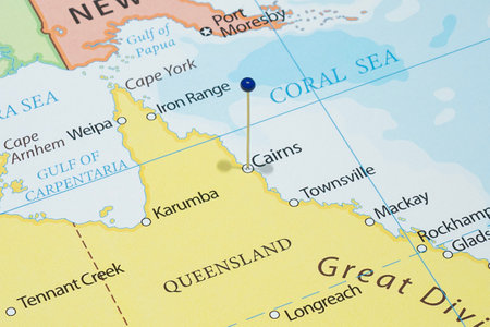 Close up to a Cairns city with a blue pin needle into Australia country political mapの写真素材