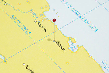Close up to a Bilibino city with a red pin needle into Russia country political mapの写真素材