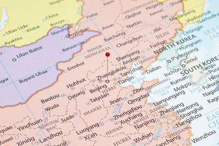 Close up to a Beijing city with a red pin needle into China country political mapの写真素材