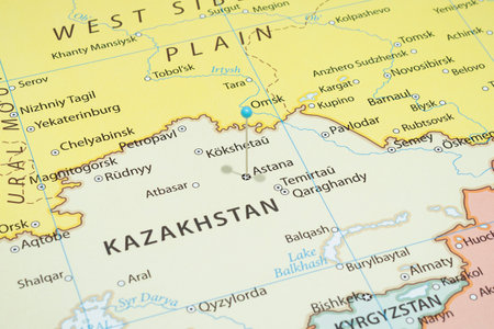 Close up to a Astana city with a light blue pin needle into Kazakhstan country political mapの写真素材