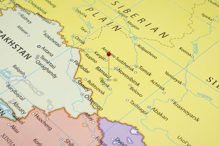 Close up to a Barnaul city with a red pin needle into Russia country political map