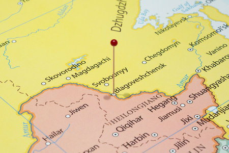 Close up to a Blagoveshchensk city with a red pin needle into Russia country political mapの写真素材