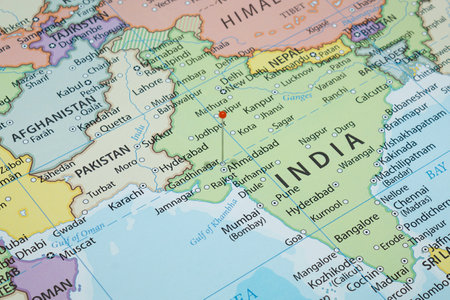 Close up to a Gandhinagar city with an orange pin needle into India country political mapの写真素材