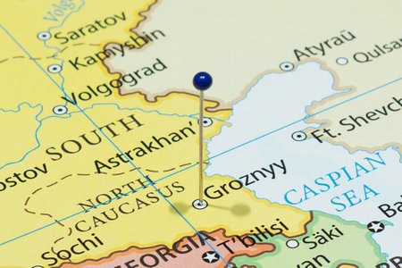 Close up to a Grozny city with a blue pin needle into Russia country political mapの写真素材