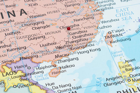 Close up to a Guangzhou city with a red pin needle into China country political mapの写真素材