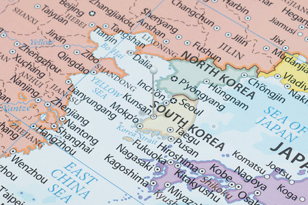 Close up to a Gunsan city with a white pin needle into South Korea country political mapの写真素材