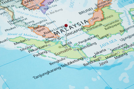 Close up to a Jambi city with a red pin needle into Indonesia country political mapの写真素材