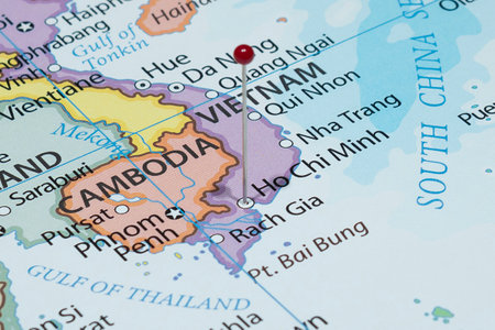 Close up to a Ho Chi Minh city with a red pin needle into Vietnam country political map