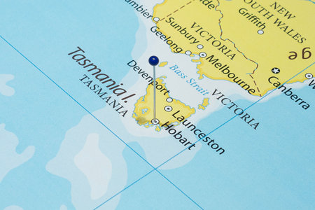 Close up to a Hobart city with a blue pin needle into Australia country political map