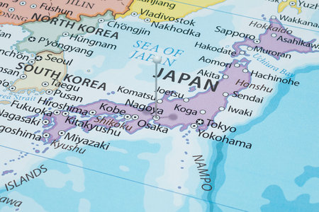 Close up to a Nagoya city with a white pin needle into Japan country political mapの写真素材