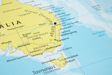 Macro photo of Canberra city with a blue pin needle into Australia country political mapの写真素材