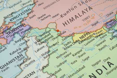 Close up to a city with an orange pin needle into India country political mapの写真素材