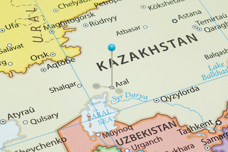 Close up to a Aral city with a light blue pin needle into Kazakhstan country political mapの写真素材
