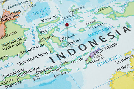 Close up to a Baubau city with a red pin needle into Indonesia country political mapの写真素材