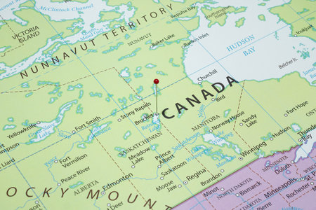 Close up to a Brochet city with a red pin needle into Canada country political mapの写真素材
