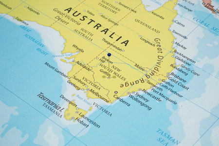 Close up to a Griffith city with a blue pin needle into Australia country political mapの写真素材