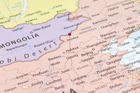 Close up to a Hohhot city with a red pin needle into China country political mapの写真素材