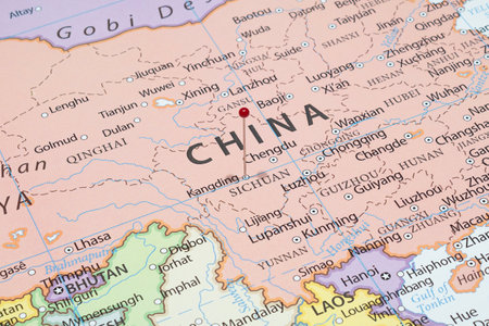 Close up to a Kangding city with a red pin needle into China country political mapの写真素材