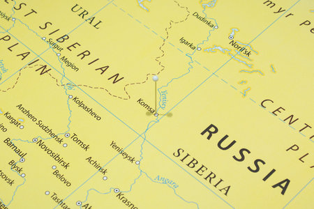 Close up to a Komsa city with a white pin needle into Russia country political mapの写真素材