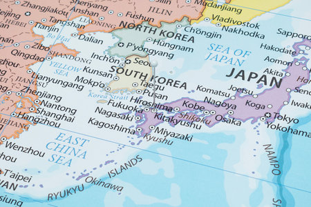 Close up to a Kitakyushu city with a white pin needle into Japan country political mapの写真素材