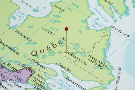 Close up to a Labrador City city with a red pin needle into Canada country political mapの写真素材