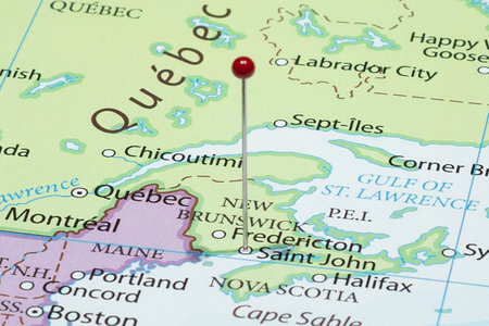 Close up to a Saint John city with a red pin needle into Canada country political mapの写真素材