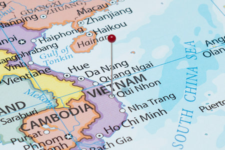 Close up to a Qui Nhon city with a red pin needle into Vietnam country political mapの写真素材
