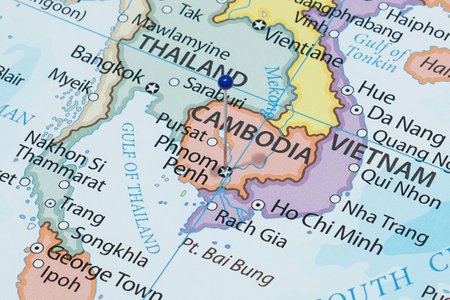 Close up to a Phnom Penh city with a blue pin needle into Cambodia country political mapの写真素材