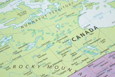 Close up to a Stony Rapids with a white pin needle into Canada country political mapの写真素材