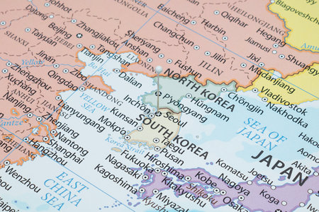 Close up to a Seoul city with a white blue pin needle into South Korea country political mapの写真素材