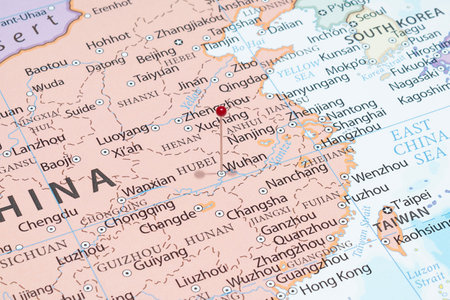 Close up to a Wuhan city with a red pin needle into China country political mapの写真素材
