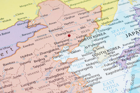 Close up to a Dalian city with a red pin needle into China country political mapの写真素材