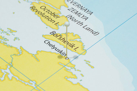 Close up to a Cape Chelyuskin city with a white pin needle into Russia country political map