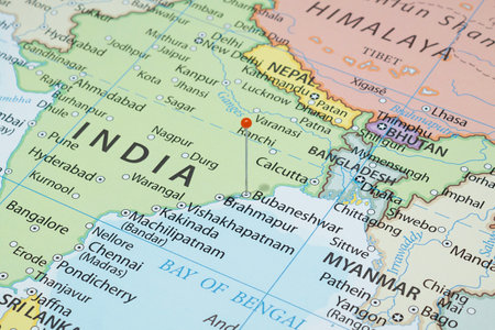 Close up to a Bubaneshwar city with an orange pin needle into India country political mapの写真素材