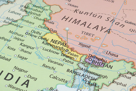 Close up to a Kathmandu city or Lalitpur city with a white pin needle into Nepal country political mapの写真素材