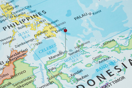 Close up to a Manado city with a red pin needle into Indonesia country political mapの写真素材