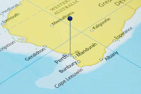 Close up to a Perth city with a blue pin needle into Australia country political mapの写真素材