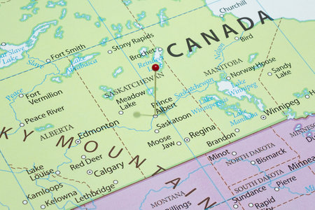 Close up to a Prince Albert city with a red pin needle into Canada country political mapの写真素材