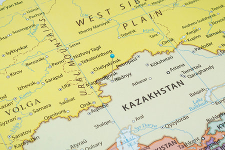 Close up to a Rudny city with a light blue pin needle into Kazakhstan country political mapの写真素材