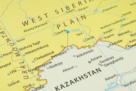 Close up to a Petropavl city with a light blue pin needle into Kazakhstan country political mapの写真素材